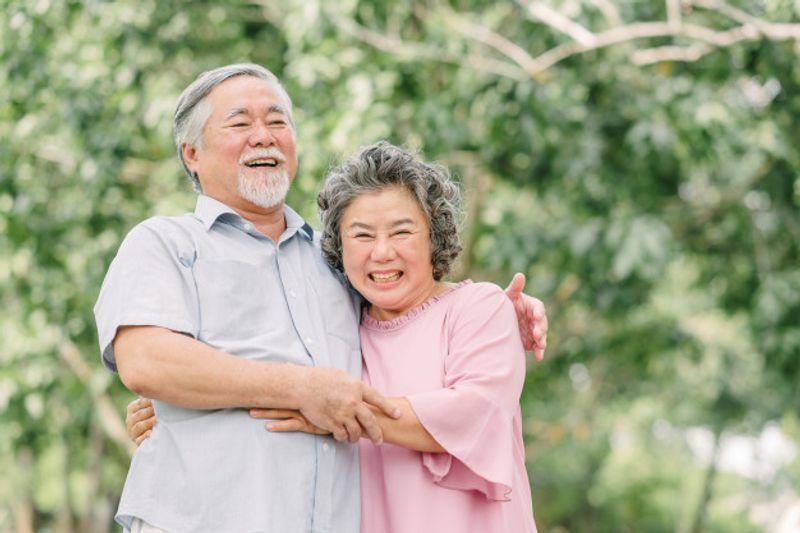 happy-senior-couple-holding-each-other-park_34840-348
