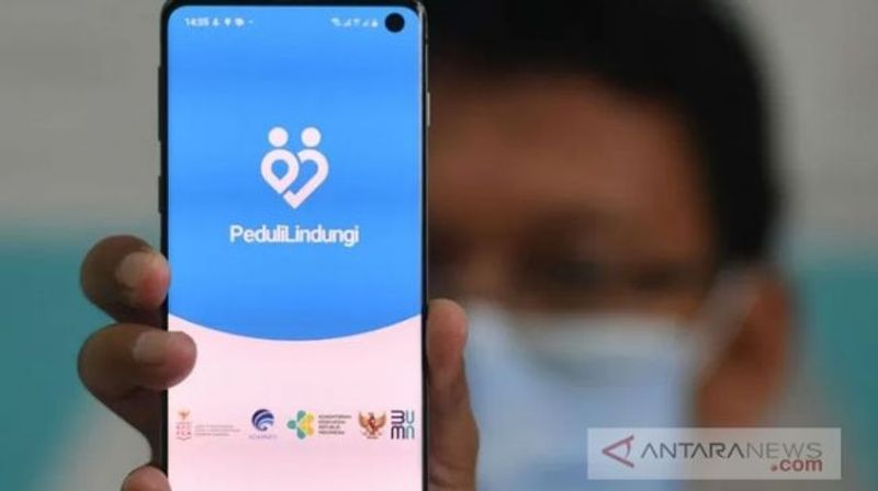 22165-seorang-warga-menunjukan-aplikasi-pedulilindungi-yang-telah-diinstal-pada-