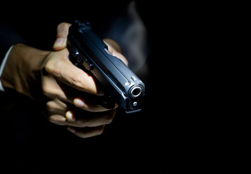 close-up-gunman-dark-background