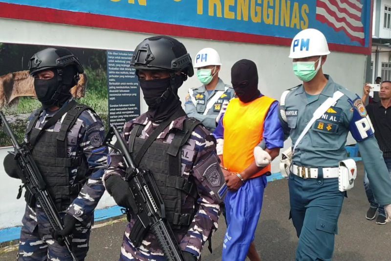 Personel TNI AL bersenjata lengkap menggiring seorang tersangka jaringan narkoba internasional