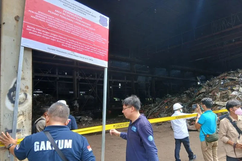 Petugas Kementerian Lingkungan Hidup (LH) memasang plang penyegelan kegiatan pabrik peleburan besi