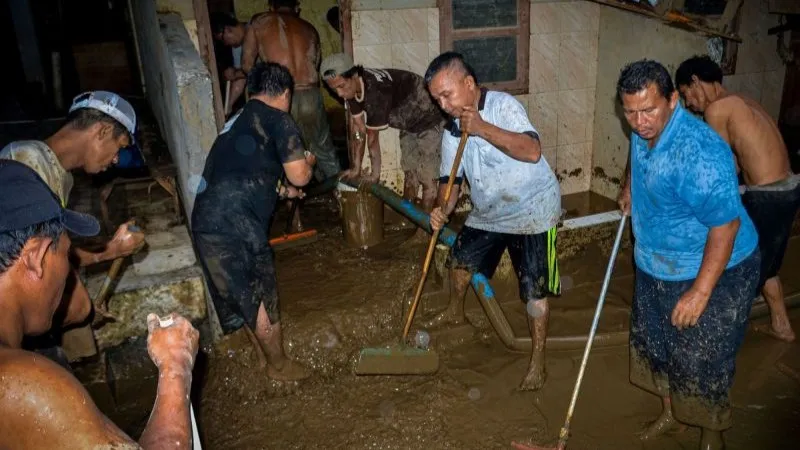 Warga membersihkan lumpur sisa banjir di Pejaten