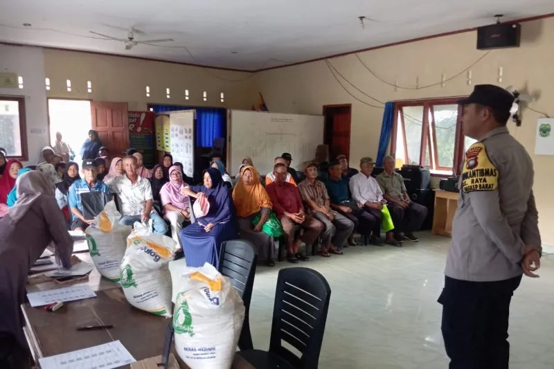 Anggota Bhabinkamtibmas Polres Lingga mengawal penyaluran bantuan pangan beras