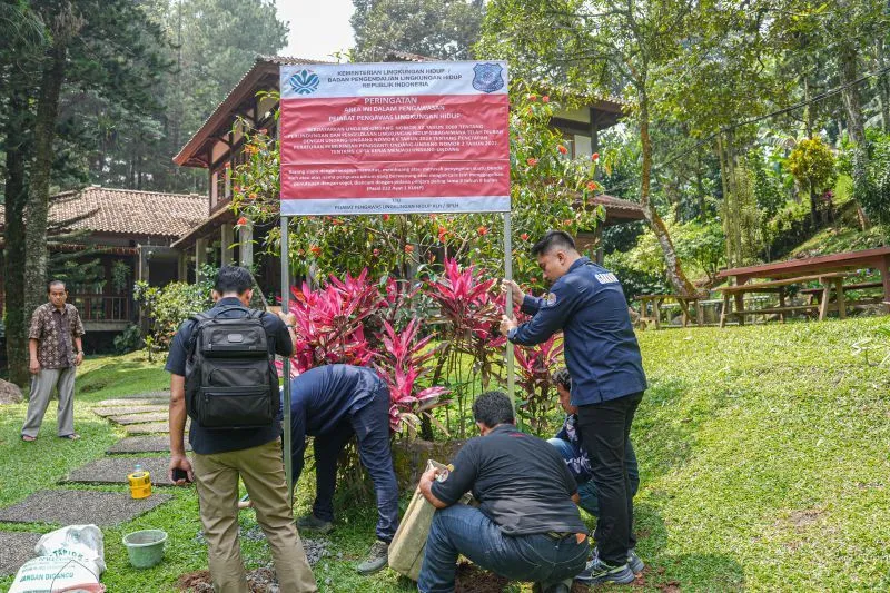 Tim Gakkum KLH memasang papan pengawasan ketika menyegel empat hotel di Puncak