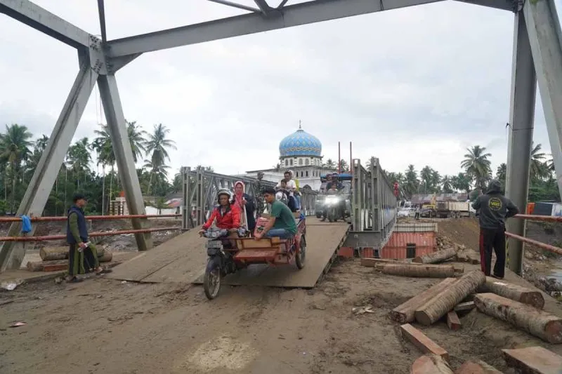 Warga menggunakan becak motor melintas di jembatan bailey di Teupin Mane Bireun