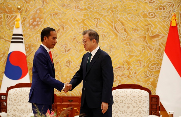Indonesian President Joko Widodo shakes hands with South Korean President Moon Jae-in during their meeting at the Presidential Blue House in Seoul