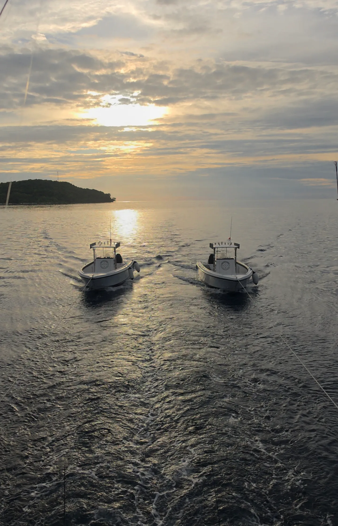 The two sportfisher boats under tow at sunrise